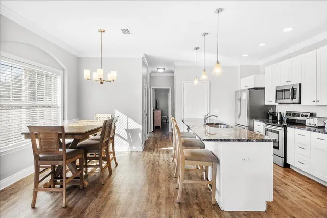 a bathroom with a granite countertop sink a toilet and a mirror