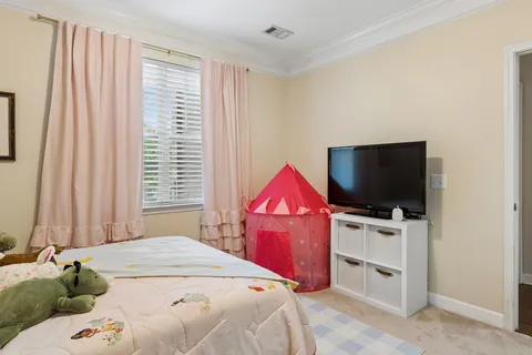 a bedroom with a bed and flat screen tv