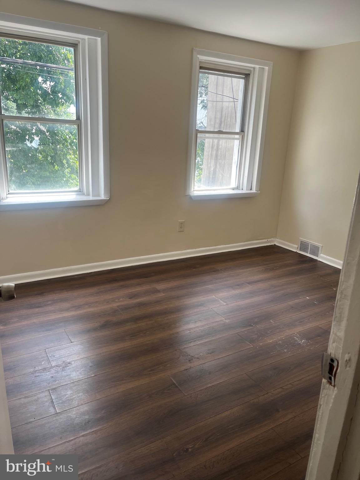 405 East Rittenhouse Street Philadelphia, PA 19144 - Photo 10 of 12 a view of an empty room with wooden floor and a window