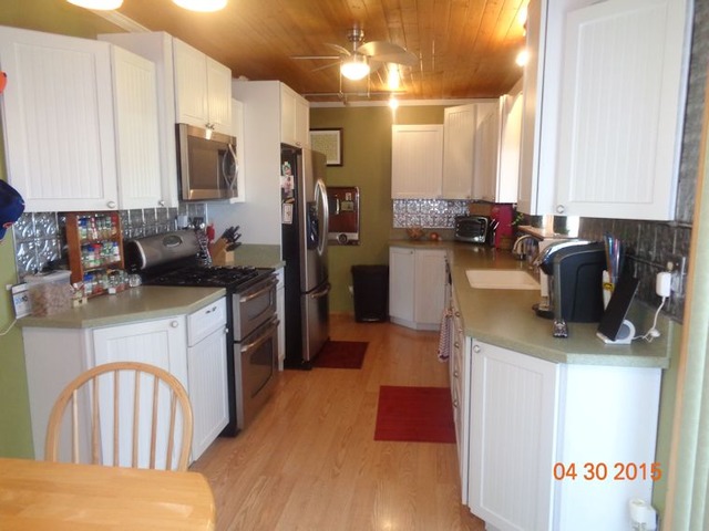 1001 North 3rd Street Rochelle, IL 61068 - Photo 2 of 12 a kitchen with a refrigerator and a stove top oven