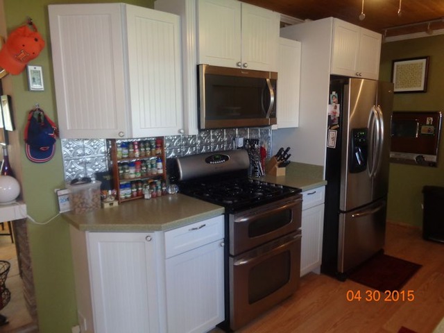 1001 North 3rd Street Rochelle, IL 61068 - Photo 3 of 12 a kitchen with stainless steel appliances granite countertop a stove refrigerator and microwave