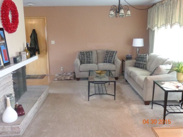 1001 North 3rd Street Rochelle, IL 61068 - Photo 5 of 12 a living room with furniture and a flat screen tv