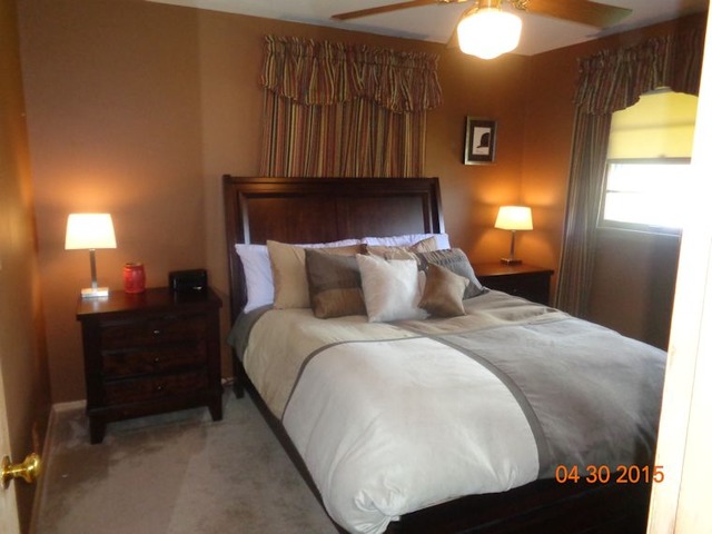 1001 North 3rd Street Rochelle, IL 61068 - Photo 8 of 12 a bedroom with a bed and a lamp