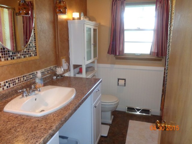 1001 North 3rd Street Rochelle, IL 61068 - Photo 10 of 12 a bathroom with a sink and a toilet
