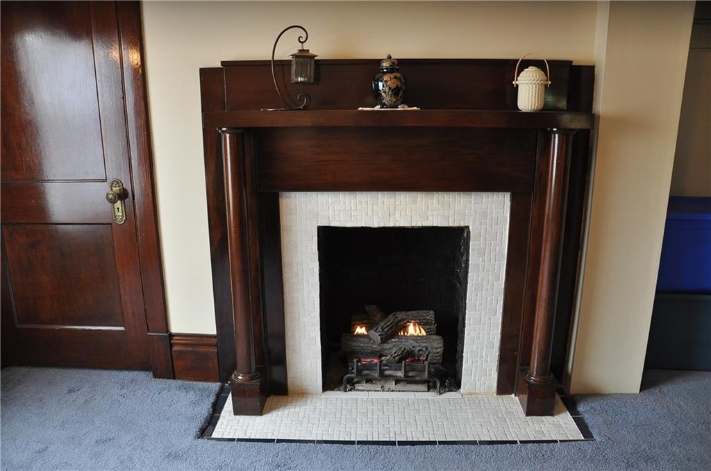343 Roosevelt Road Pittsburgh, PA 15237 - Photo 16 of 25 Gas burning fireplace surrounded by warm, rich original wooden mantel and decorative tile.