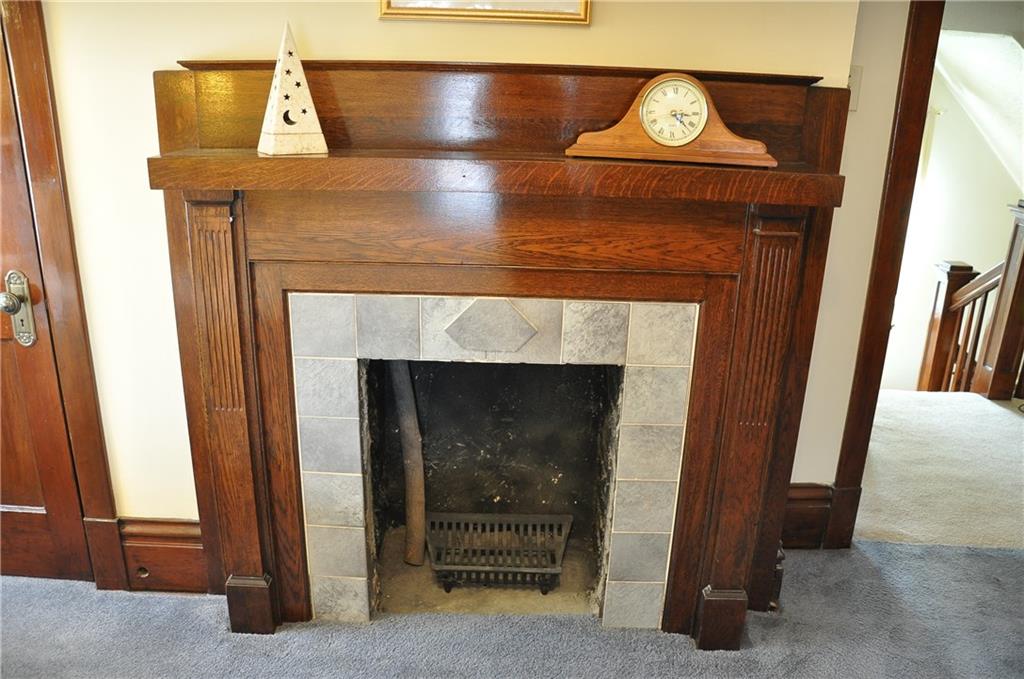 343 Roosevelt Road Pittsburgh, PA 15237 - Photo 18 of 25 Fireplace surrounded by decorative tile and original wooden mantel.
