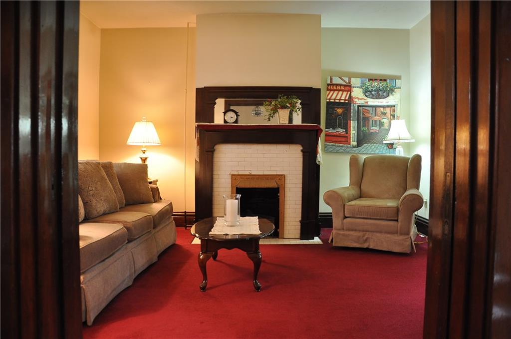343 Roosevelt Road Pittsburgh, PA 15237 - Photo 8 of 25 Enter living room through original wooden pocket doors, framing gas burning fireplace.