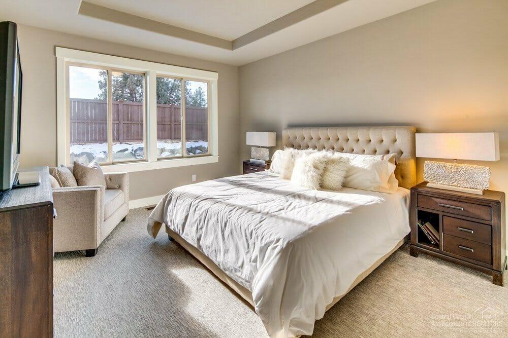 3810 Northeast Oakside Loop Bend, OR 97701 - Photo 11 of 23 a bedroom with a large bed and a large window