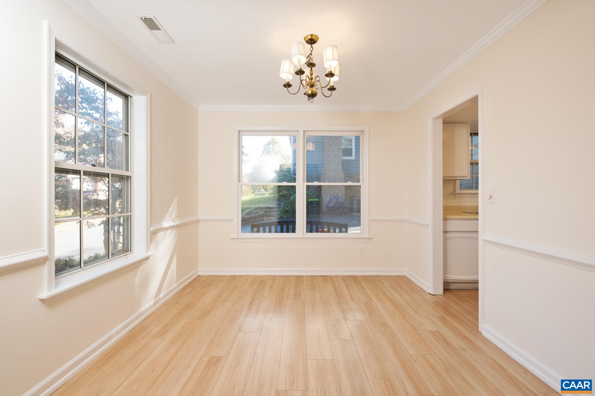 1115 Cottonwood Road Charlottesville, VA 22901 - Photo 17 of 41 a view of an empty room with wooden floor and a window