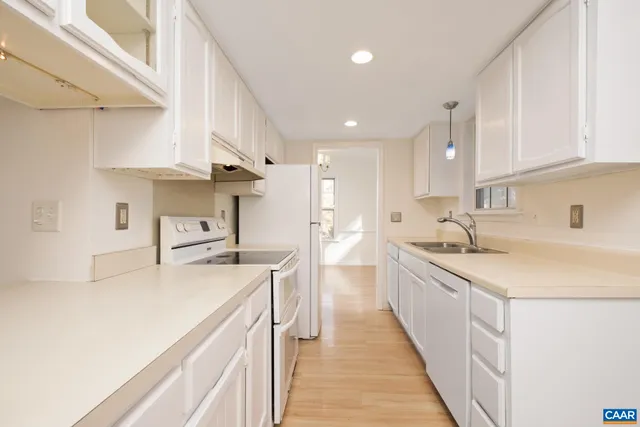 a kitchen with a refrigerator and a sink