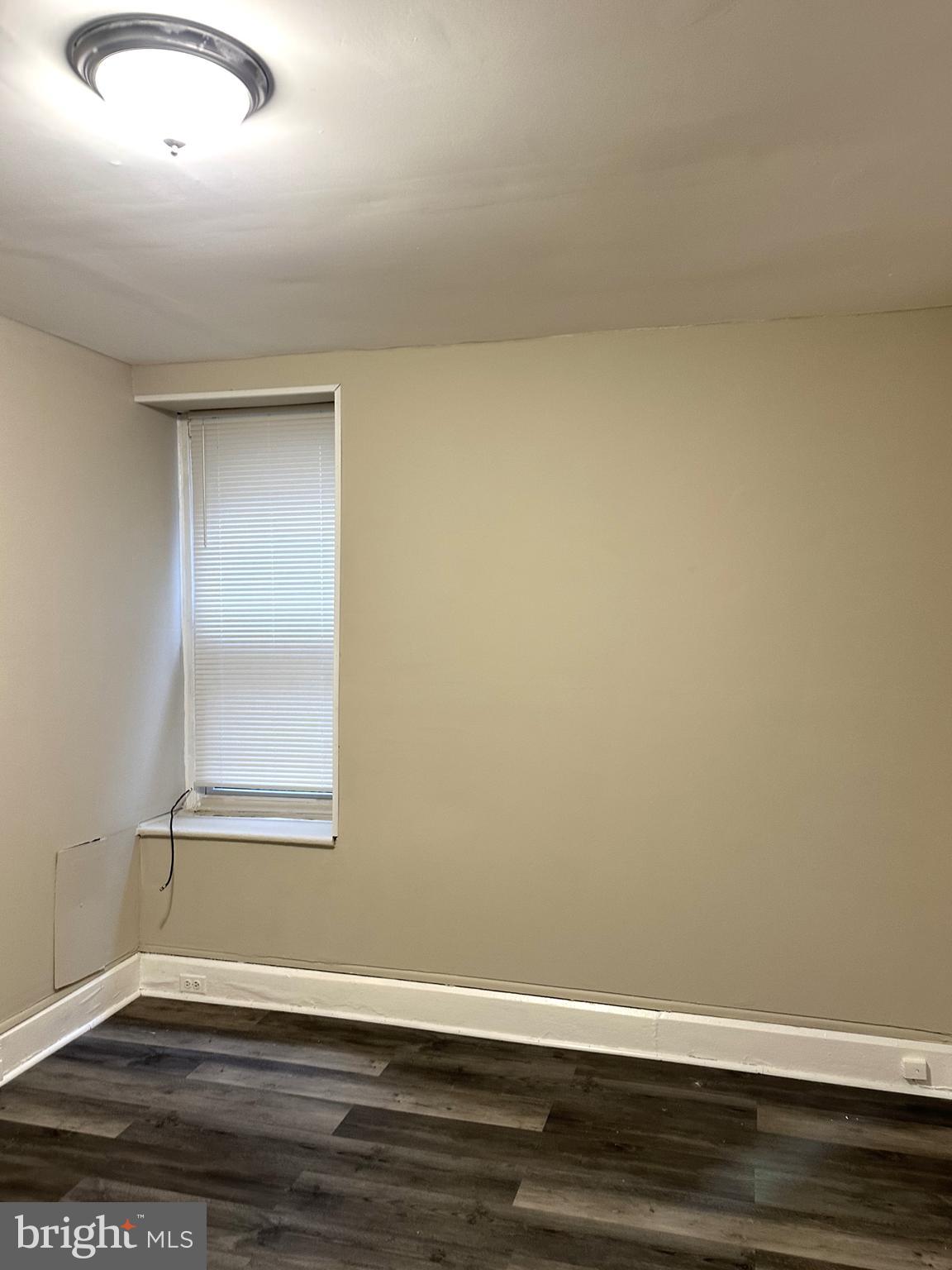 425 Highland Avenue, Unit A Chester, PA 19013 - Photo 16 of 24 an empty room with wooden floor and windows