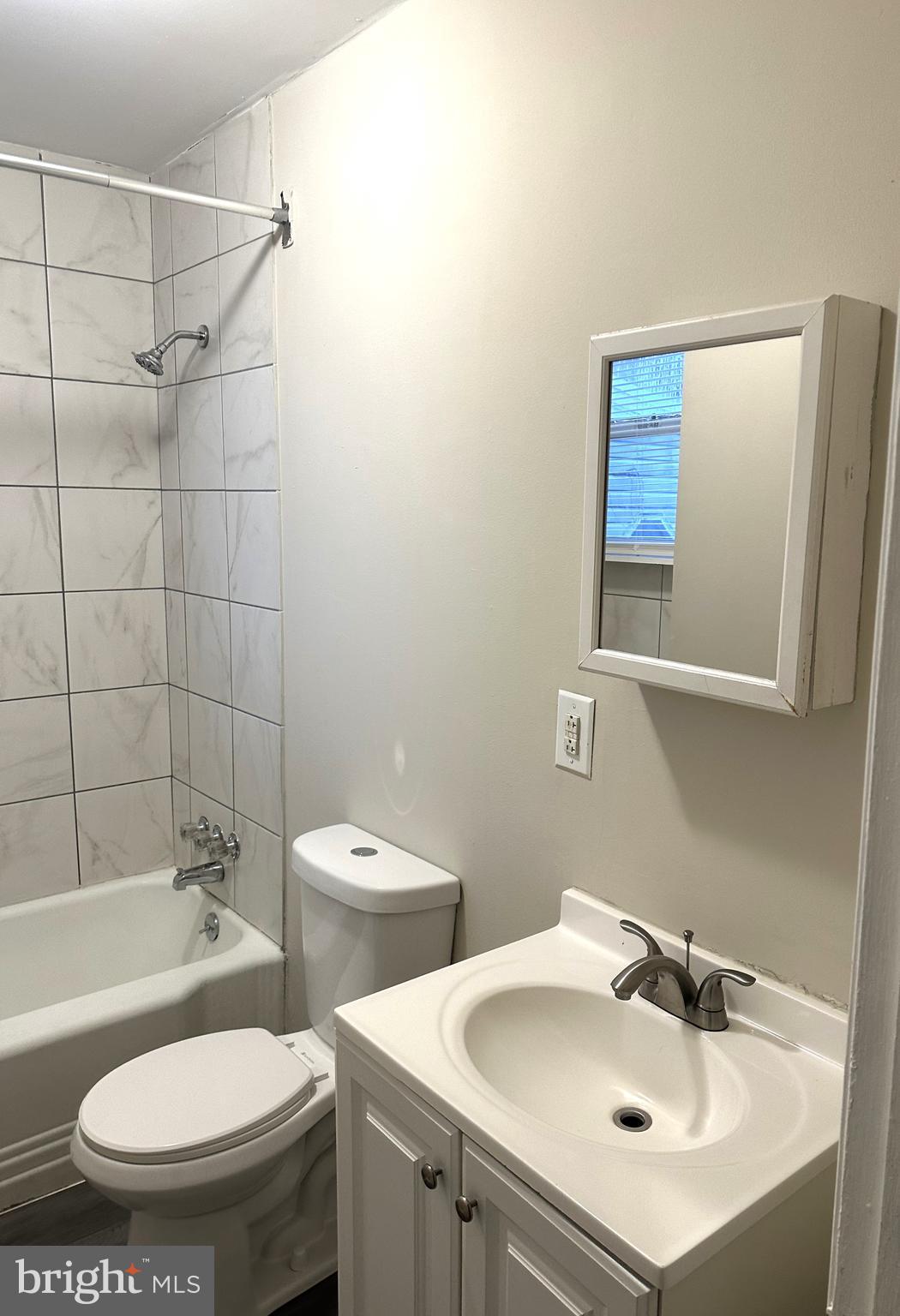 425 Highland Avenue, Unit A Chester, PA 19013 - Photo 18 of 24 a bathroom with a sink toilet a mirror and shower