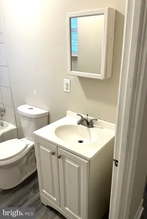 a bathroom with a toilet sink and mirror