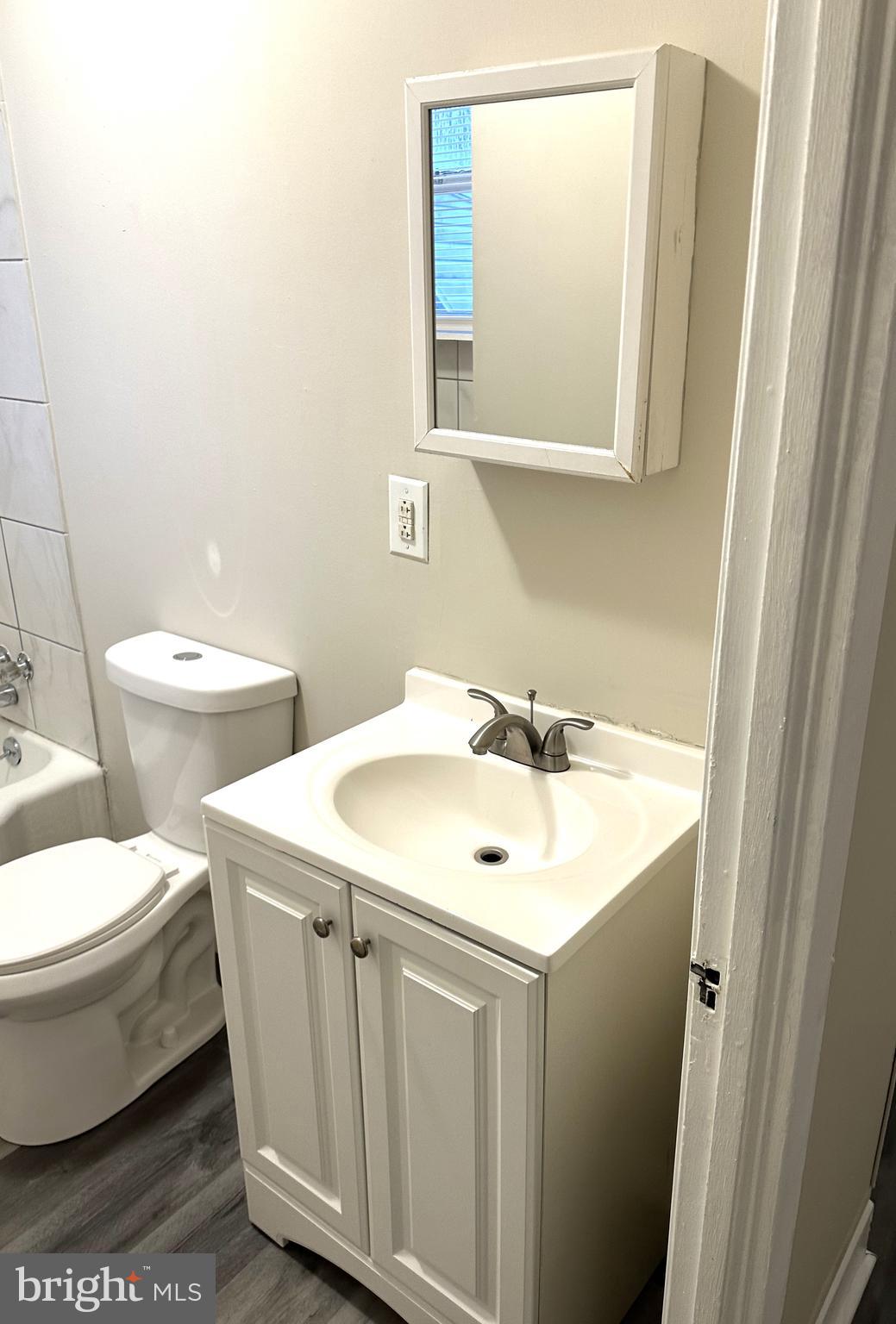 425 Highland Avenue, Unit A Chester, PA 19013 - Photo 19 of 24 a bathroom with a toilet sink and mirror