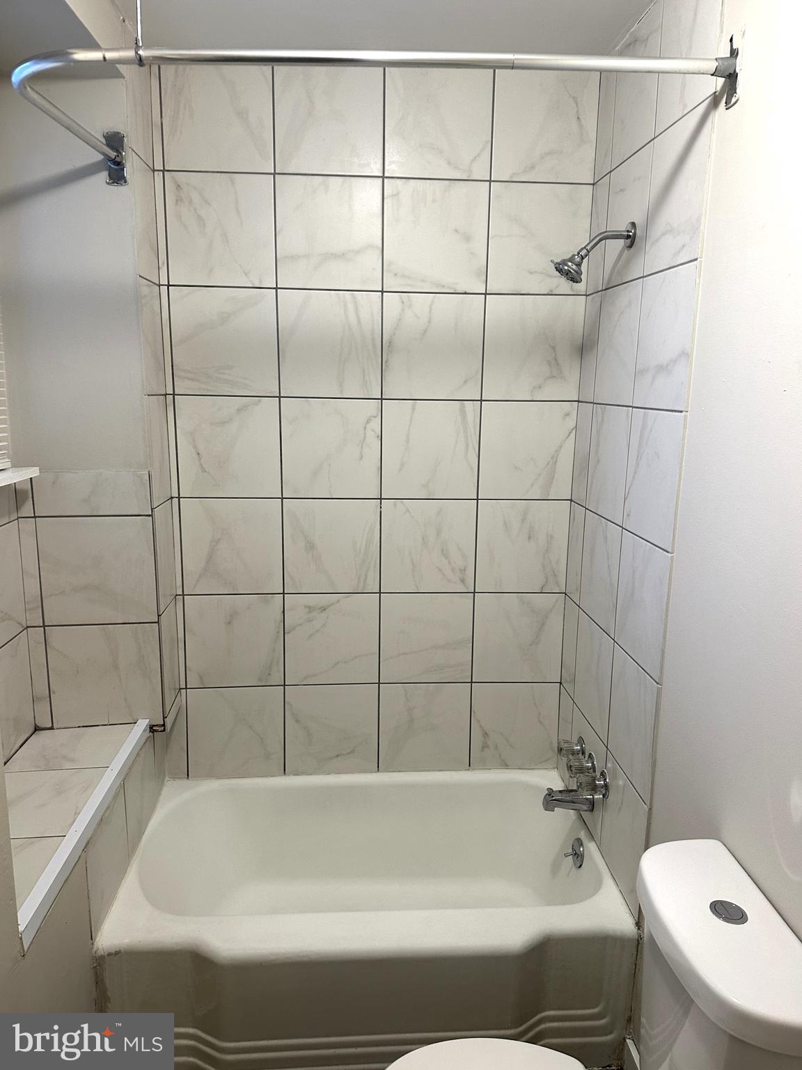 425 Highland Avenue, Unit A Chester, PA 19013 - Photo 20 of 24 a bathroom with a bathtub and a toilet