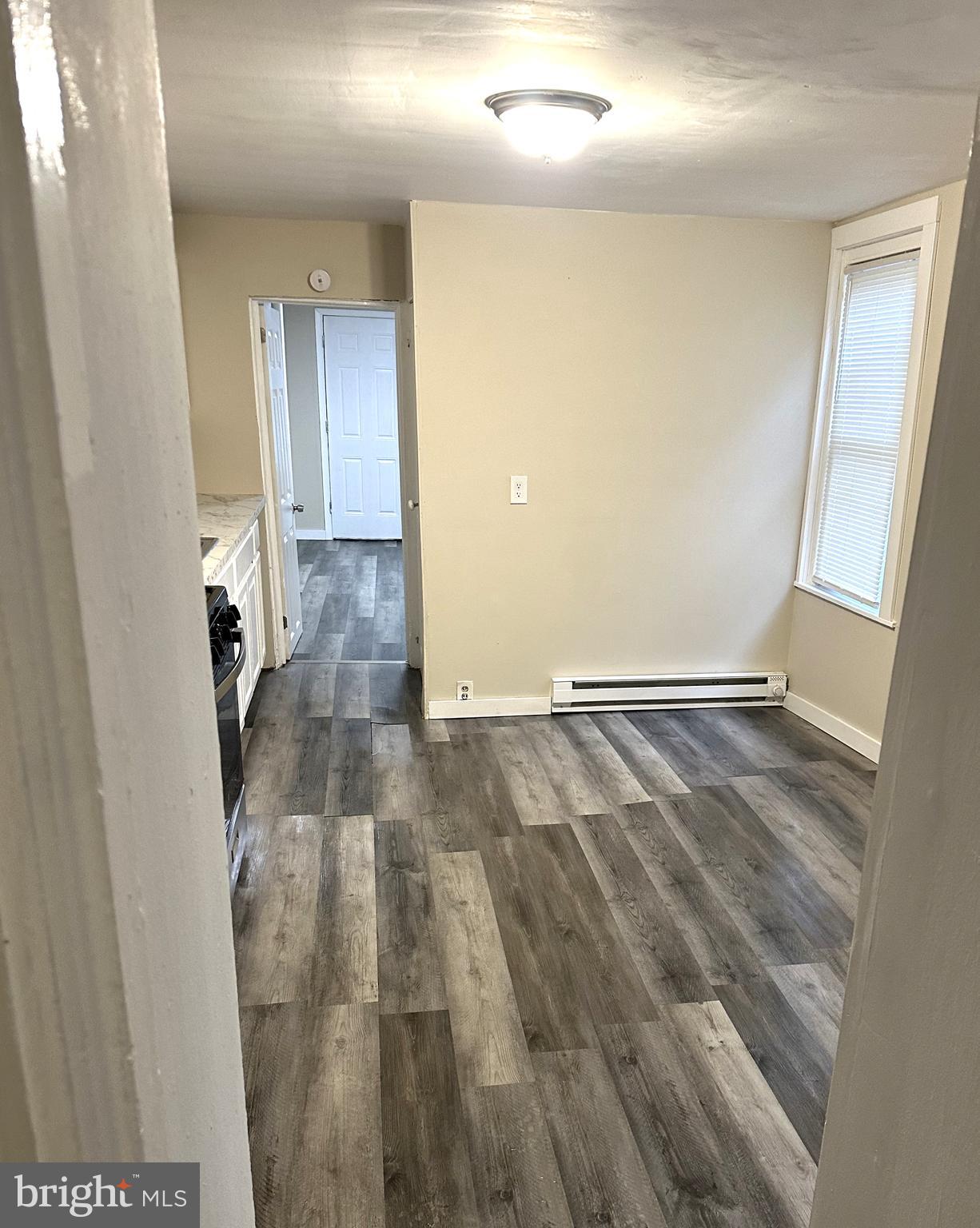 425 Highland Avenue, Unit A Chester, PA 19013 - Photo 5 of 24 wooden floor in a empty room