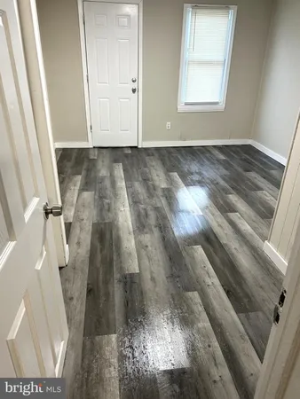 a view of an empty room and wooden floor