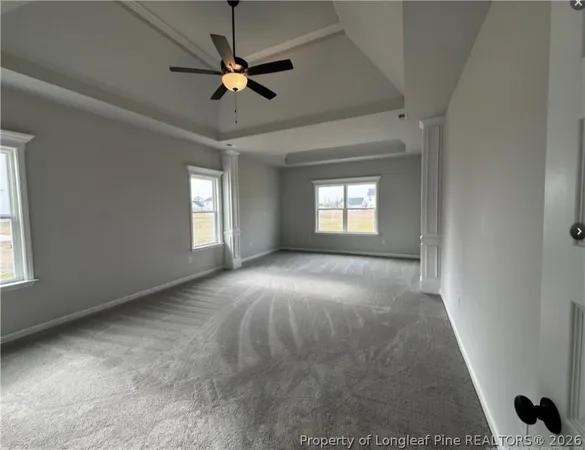 a view of a livingroom with a ceiling fan and window