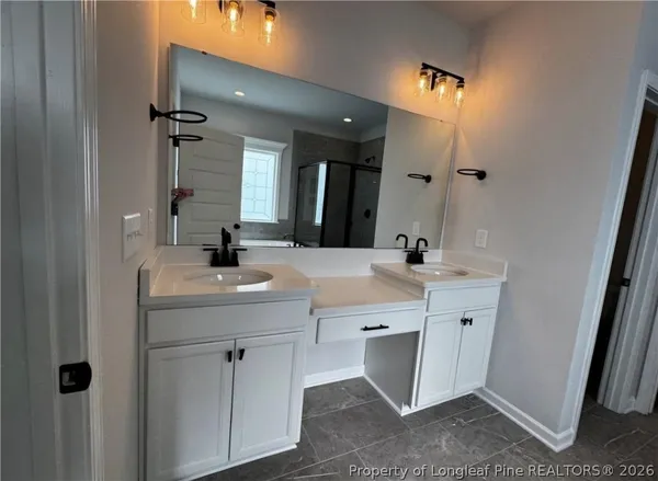 a bathroom with a double vanity sink and a mirror