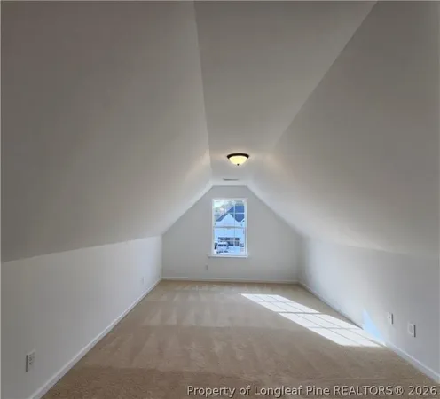 a view of an empty room and a window