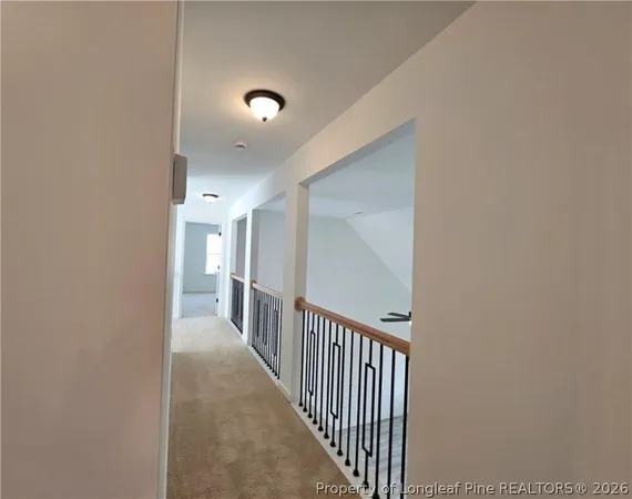 a view of a hallway with wooden floor and entryway