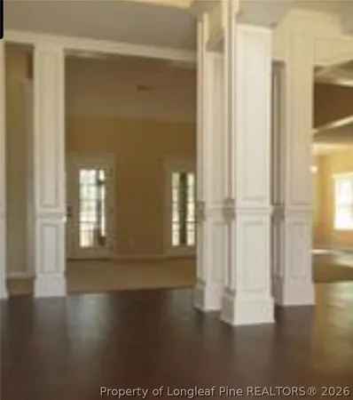 a view of wooden floor and windows in a room