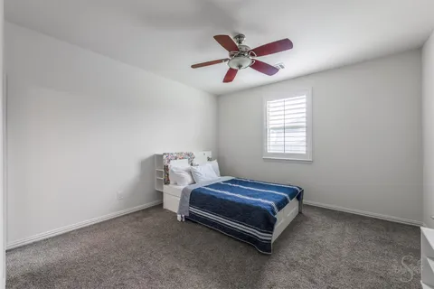a room with a bed and a chandelier