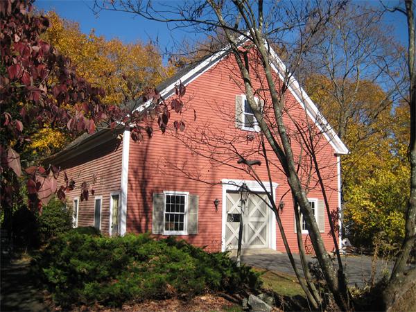 36 Great Road Maynard, MA 01754 - Photo 3 of 17 a backyard of a house with large trees and outdoor seating