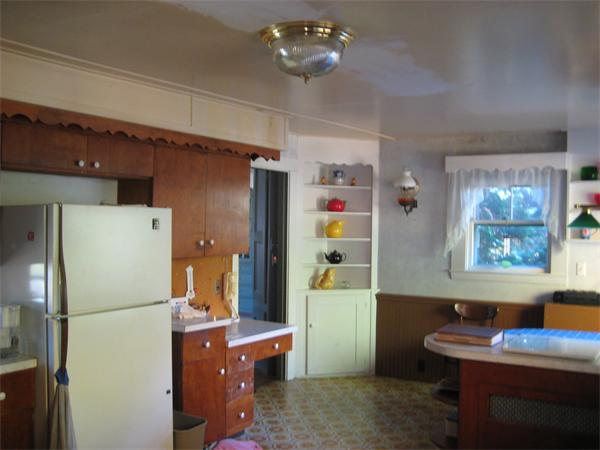 36 Great Road Maynard, MA 01754 - Photo 8 of 17 a room with furniture a refrigerator and a dresser
