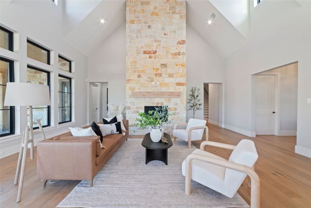 a living room with furniture fireplace and a potted plant