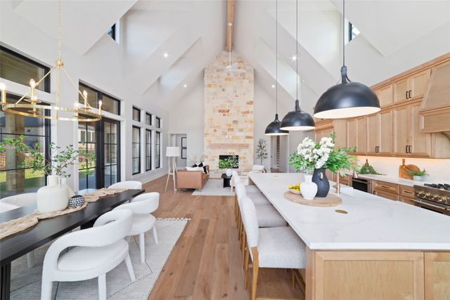 a dining room with furniture a chandelier and wooden floor