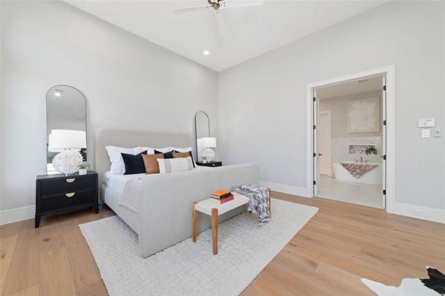 a bedroom with furniture and a wooden floor