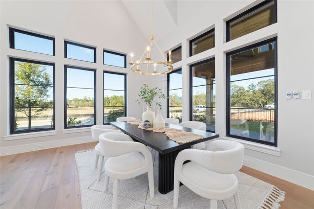 a dining room with furniture a chandelier and wooden floor