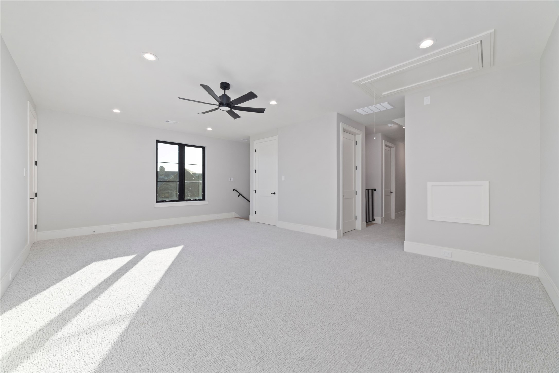 14130 Ripple Ridge Drive Willis, TX 77318 - Photo 34 of 38 an empty room with chandelier fan and windows
