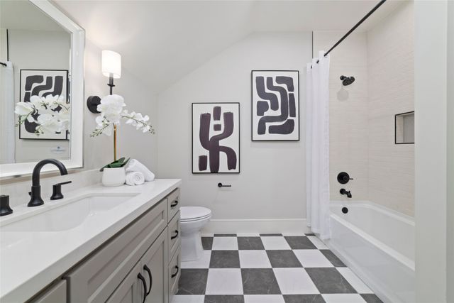 a bathroom with a sink a mirror a toilet and a bathtub