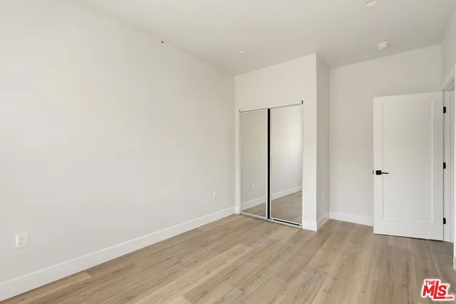 an empty room with wooden floor