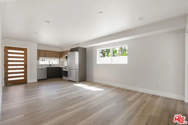 an empty room with windows and closet