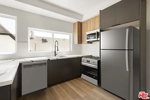 a kitchen with a refrigerator and a sink