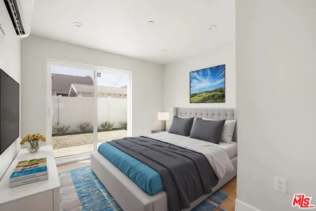 a bedroom with a large bed and a couch