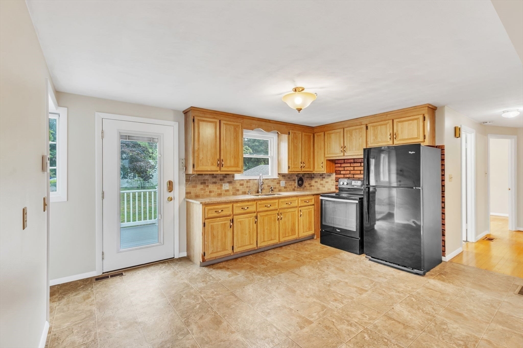 139 Prouty Street Springfield, MA 01119 - Photo 5 of 14 a kitchen with refrigerator a oven and white cabinets