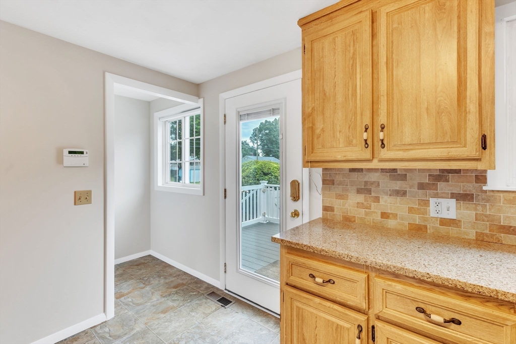 139 Prouty Street Springfield, MA 01119 - Photo 8 of 14 a kitchen with stainless steel appliances granite countertop white cabinets and a window