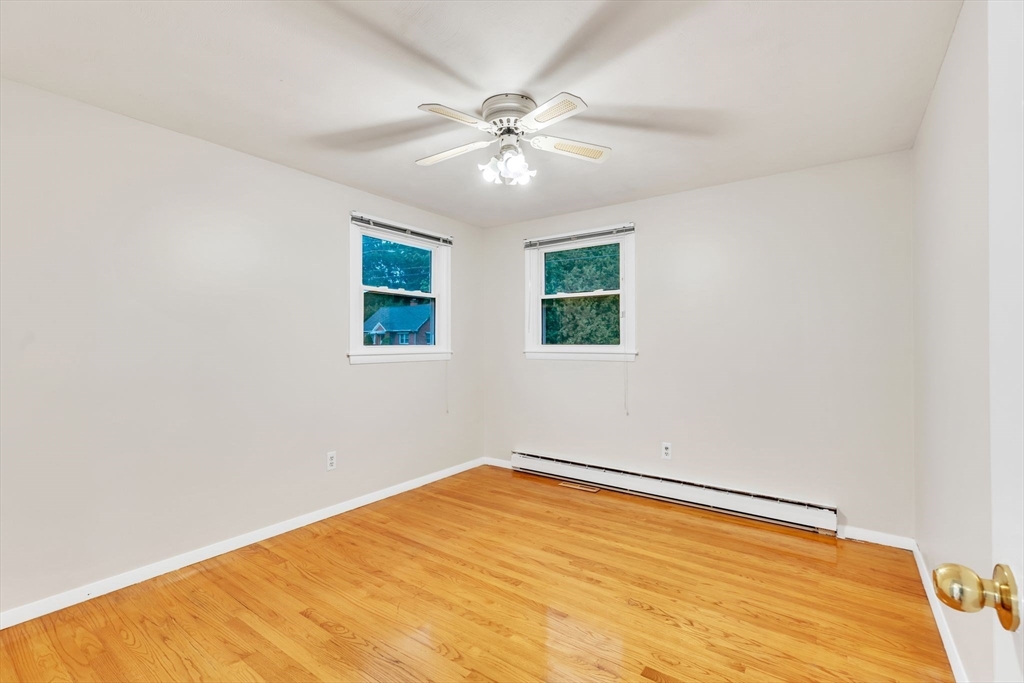 139 Prouty Street Springfield, MA 01119 - Photo 9 of 14 wooden floor in an empty room with a window