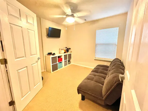 a bedroom with a bed and a painting on the wall