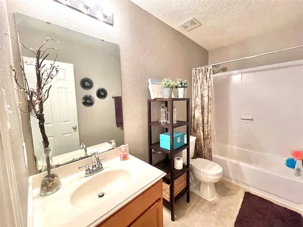 a bedroom with a bed and chandelier