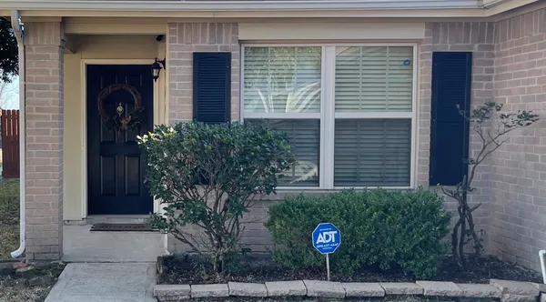a view of a house with potted plants