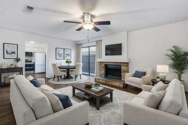 a living room with furniture a fireplace and a flat screen tv