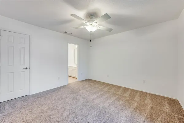 a view of a room with a ceiling fan