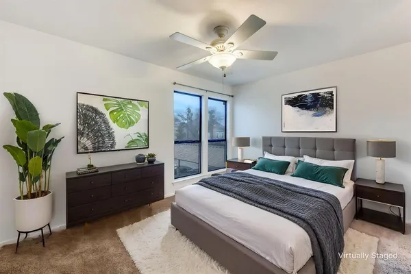 a bedroom with a large bed and a window