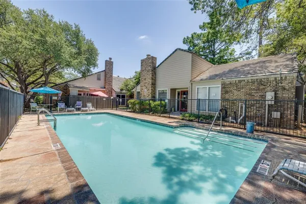 a view of a house with swimming pool and sitting area