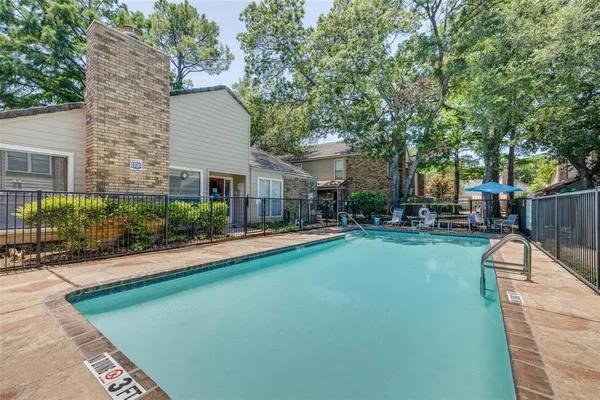 a view of a house with backyard porch and sitting area